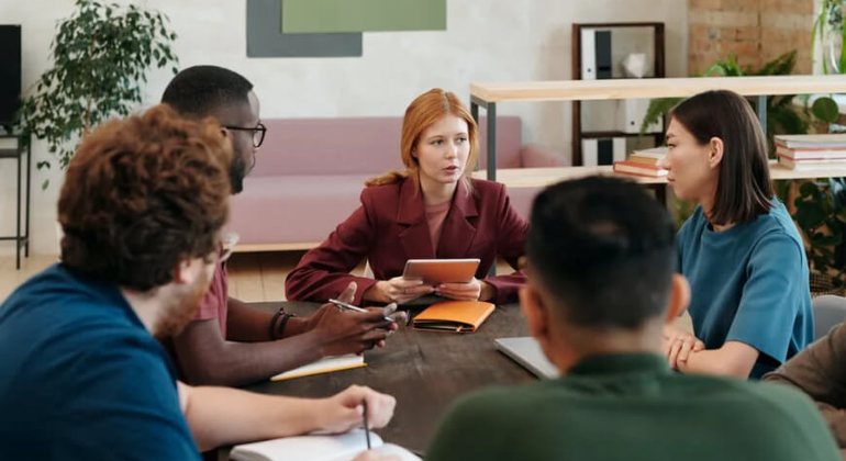 Group of professionals comparing options during a decision meeting.
